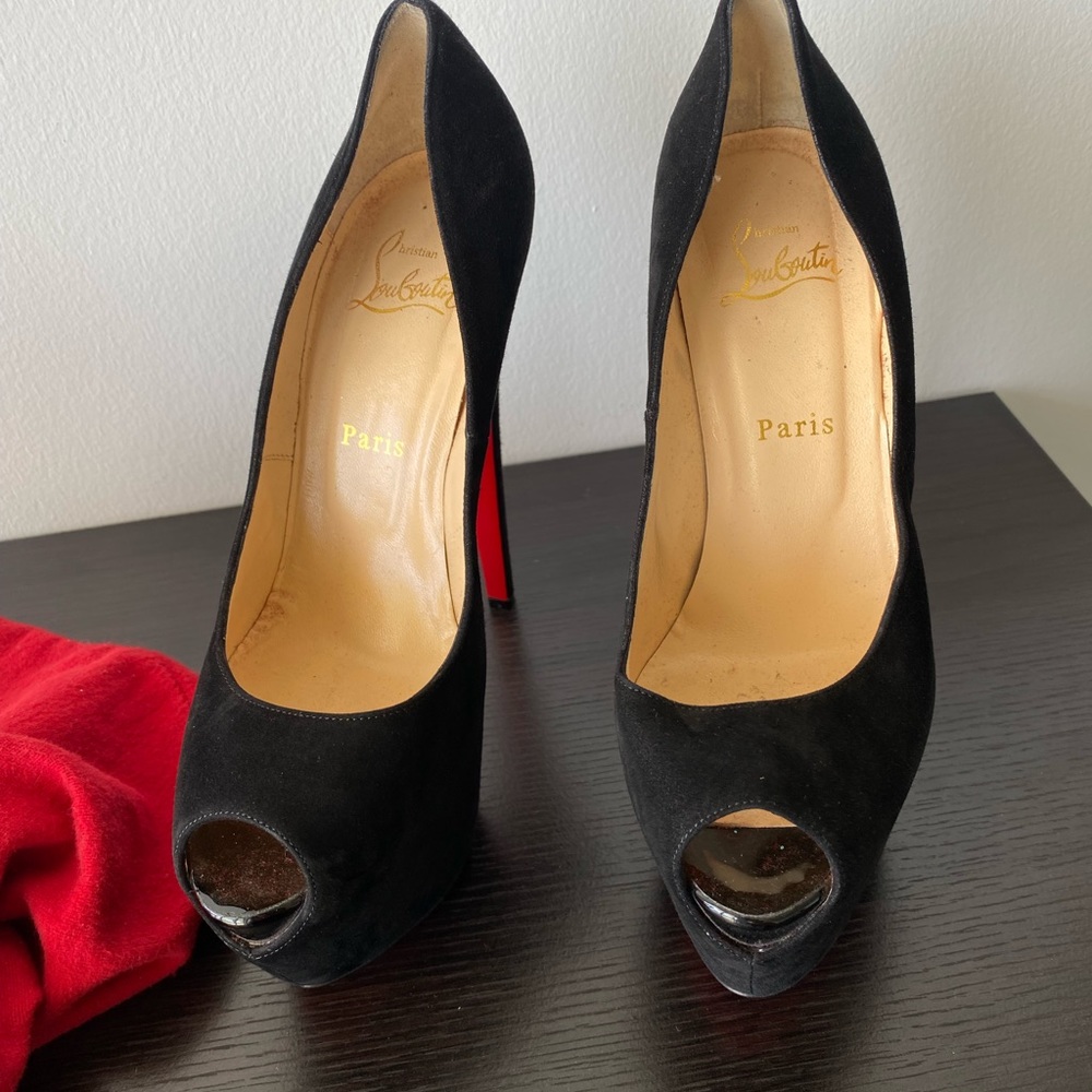 Black suede Louboutins pumps